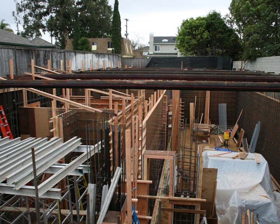 Form work and ironwork for a poured in place retaining wall and basement. Pacificland Constructors