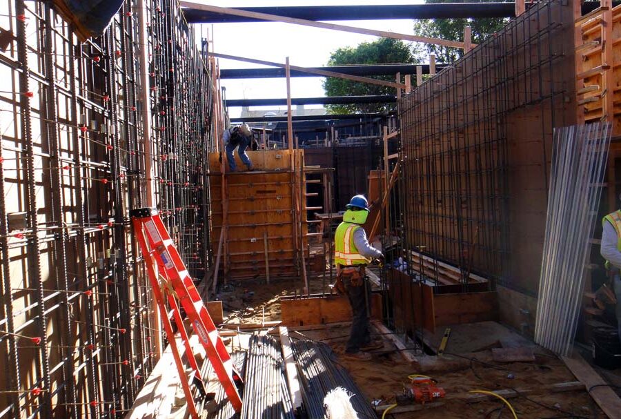 Form work and ironwork for a poured in place retaining wall and basement. Pacificland Constructors