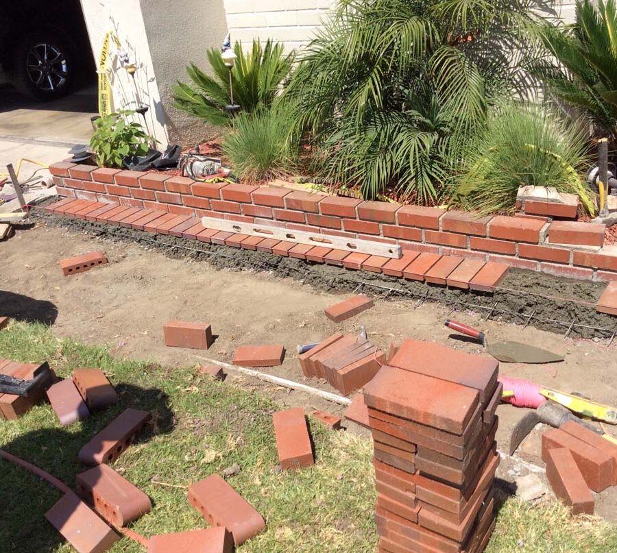 Construction of the new walkway’s brick ribbon and brick planter.