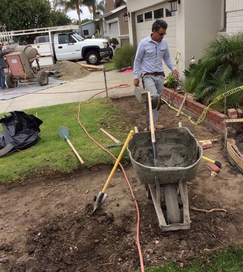 Martin, founder of Pacificland, laying red brick for a home’s front yard’s porch landing. Brick work is a great option to raise the value of your home. Pacificland Constructors