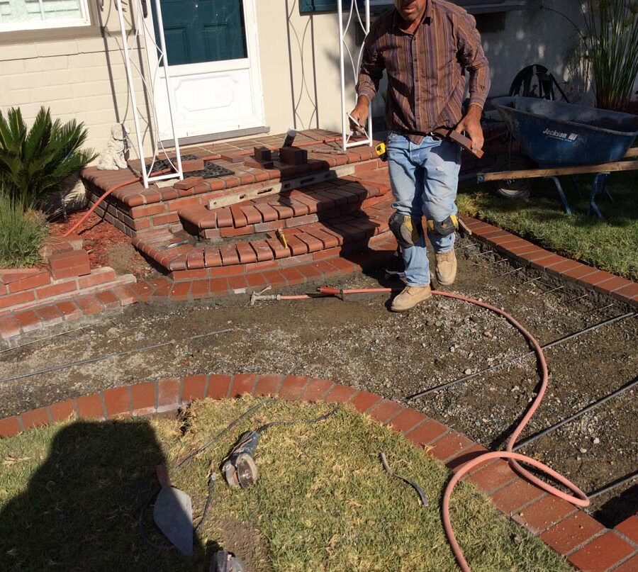 Construction of curved walkway entrance with brick ribbon and a nice brick front porch landing. The reinforced flatwork will be poured with gray concrete. Pacificland Constructors