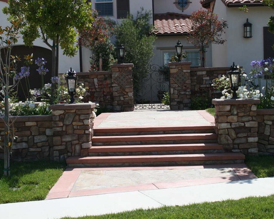 New stone veneer on the main entrance solidifies the Spanish architectural theme of the home. Pacificland Constructors