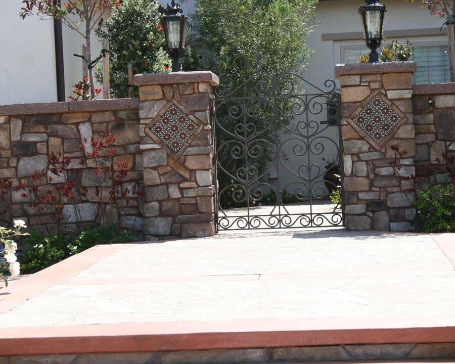 New stone veneer on the main entrance solidifies the Spanish architectural theme of the home. Pacificland Constructors