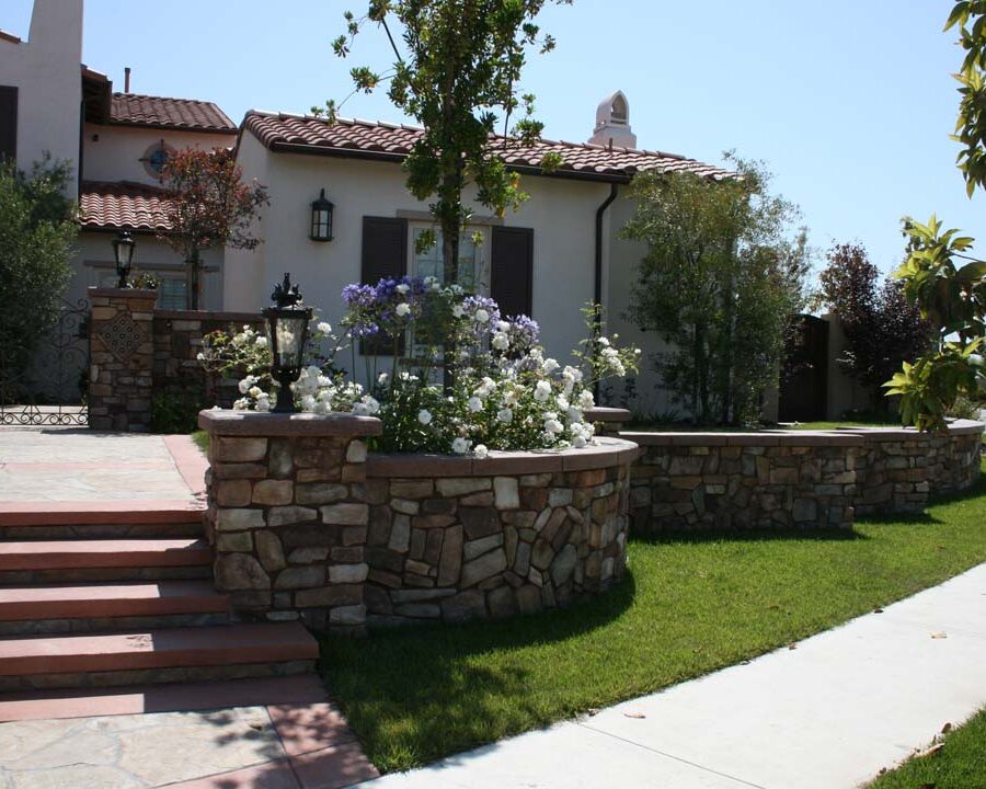 New stone veneer on the main entrance solidifies the Spanish architectural theme of the home. Pacificland Constructors