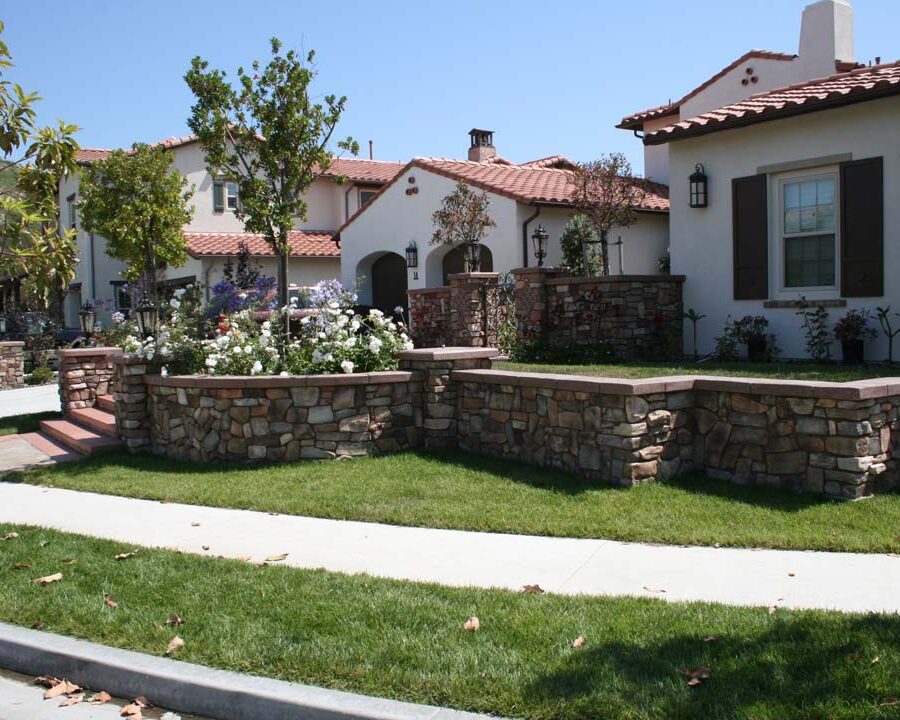 New stone veneer on the main entrance solidifies the Spanish architectural theme of the home. Pacificland Constructors