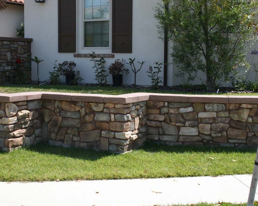 New stone veneer on the main entrance solidifies the Spanish architectural theme of the home. Pacificland Constructors