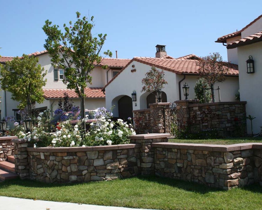 New stone veneer on the main entrance solidifies the Spanish architectural theme of the home. Pacificland Constructors