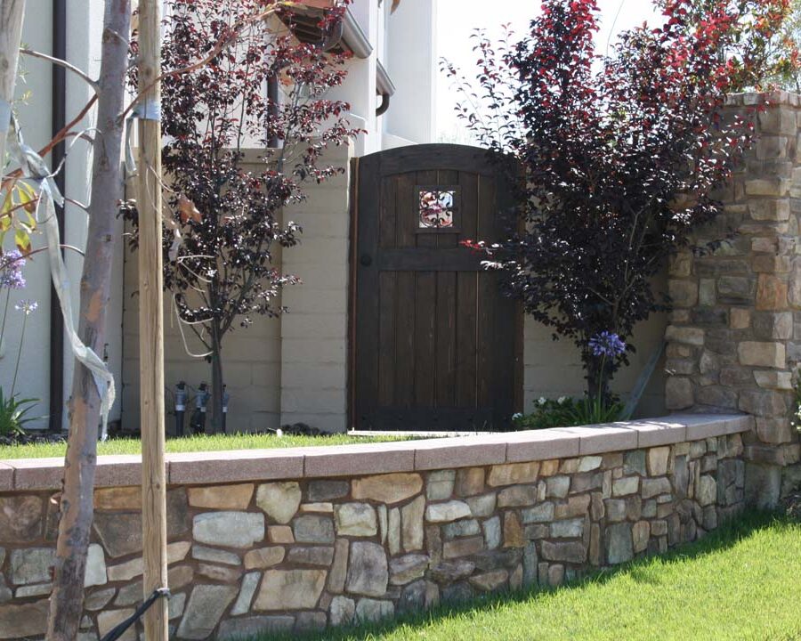 Concrete poured wall cap poured over a stone veneer concealing the CMU planter. Pacificland Constructors