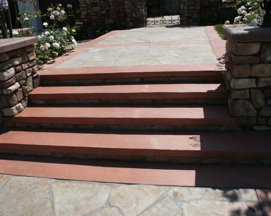 New Steps and flagstone flatwork with concrete ribbons for the entrance of this home. Stone veneered pilasters and colored wall caps create a bold vintage Spanish theme. Pacificland Constructors