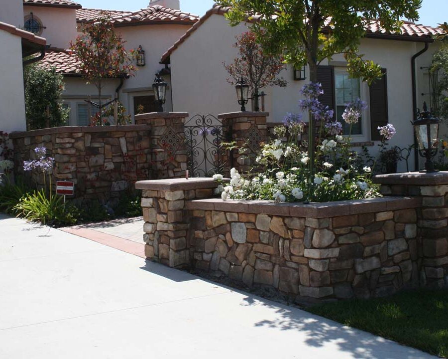 New Steps and flagstone flatwork with concrete ribbons for the entrance of this home. Stone veneered pilasters and colored wall caps create a bold vintage Spanish theme. Pacificland Constructors