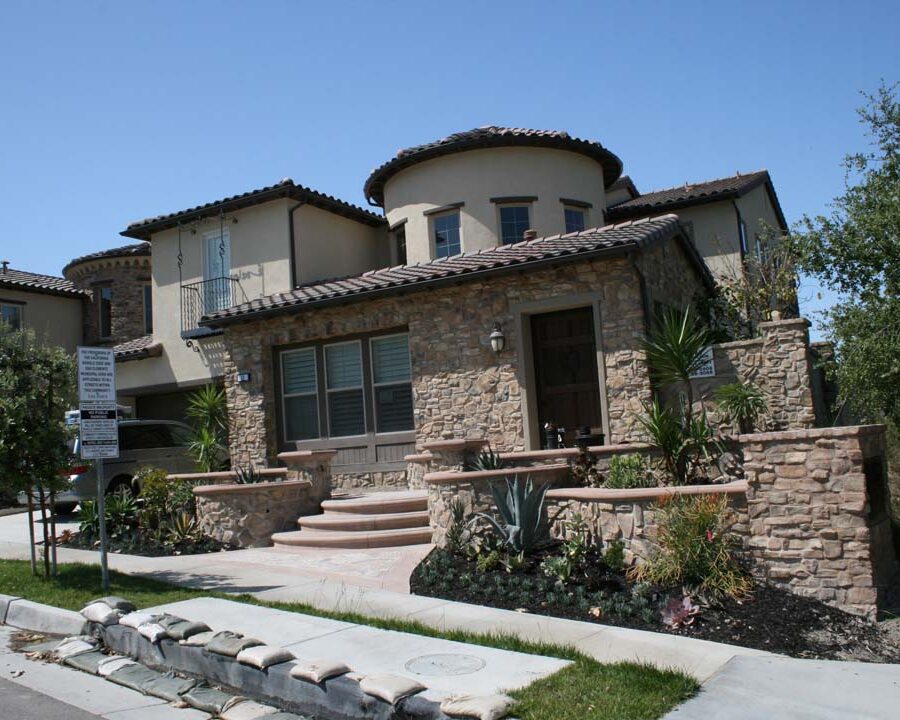 New natural stone veneer on the main entrance of the home creates an architecturally bold and vintage look. Pacificland Constructors