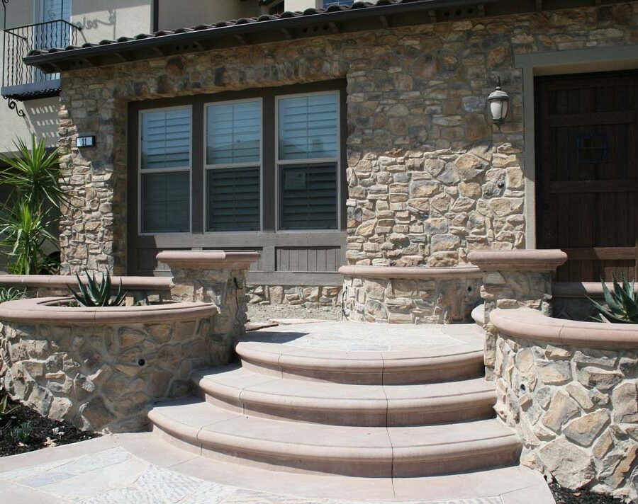 New natural stone veneer on the main entrance of the home creates an architecturally bold and vintage look. Pacificland Constructors