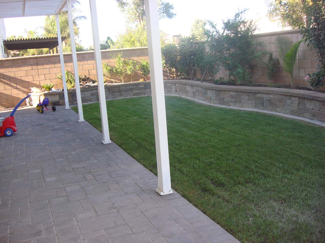 New pavers for the covered patio and stone veneer to conceal CMU planters to give the home an architecturally vintage look. Pacificland Constructors