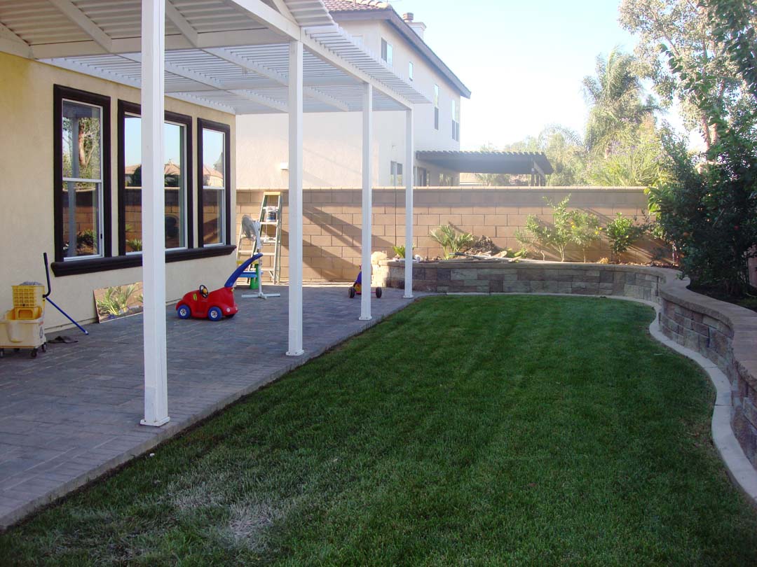 New pavers for the covered patio and stone veneer to conceal CMU planters to give the home an architecturally vintage look. Pacificland Constructors