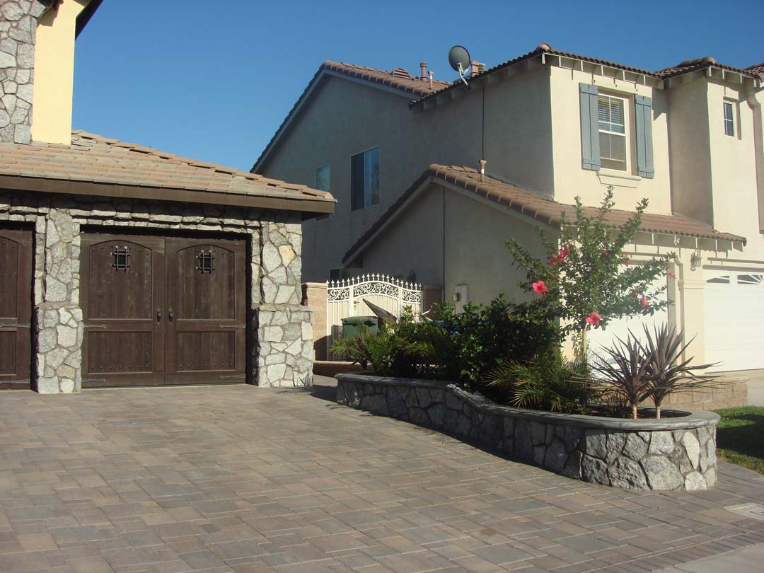 Existing stucco was removed and replaced with new stone veneer to give the home an architecturally vintage look. New planters with concrete precast wall caps match are used to match the vintage theme. Pacificland Constructors