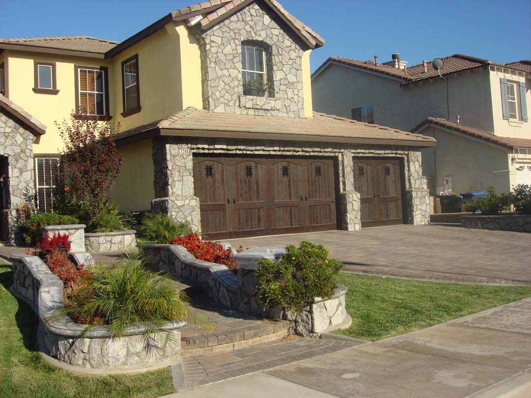 New stone veneer was placed on the exterior of the chimney by our masons to match the theme of the pavers and front yard stone-work. Pacificland Constructors