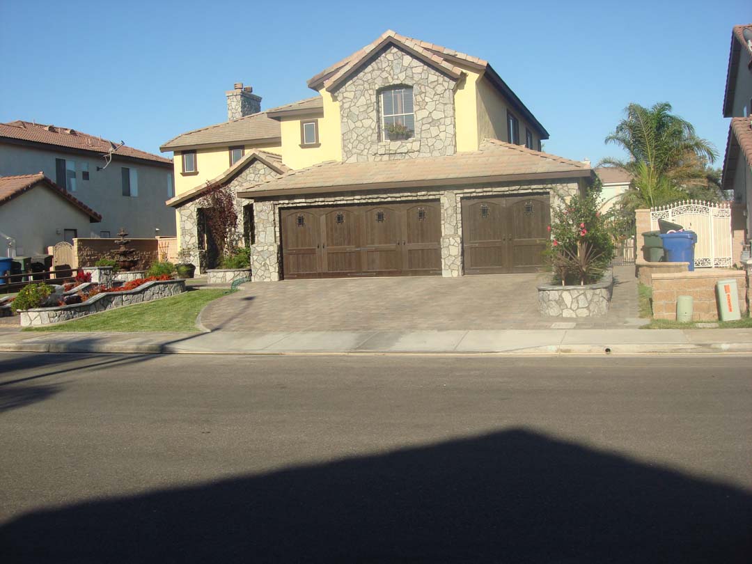 Existing stucco was removed and replaced with new stone veneer to give the home an architecturally vintage look. New planters with concrete precast wall caps match are used to match the vintage theme. Pacificland Constructors