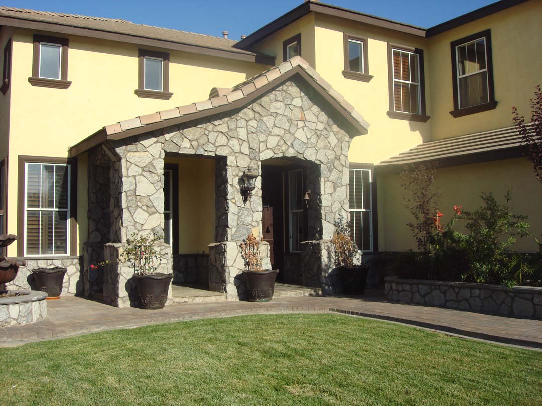 Existing stucco was removed and replaced with new stone masonry to give the home an architecturally vintage look. Pacificland Constructors