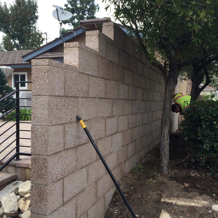 New burnished freestanding wall for a backyard along the owner’s property line.