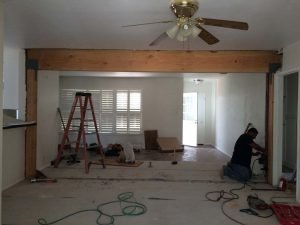 Construction of the replacement of a load bearing wall with a beam. Plaster and drywall needs to be applied prior to sanding and painting.