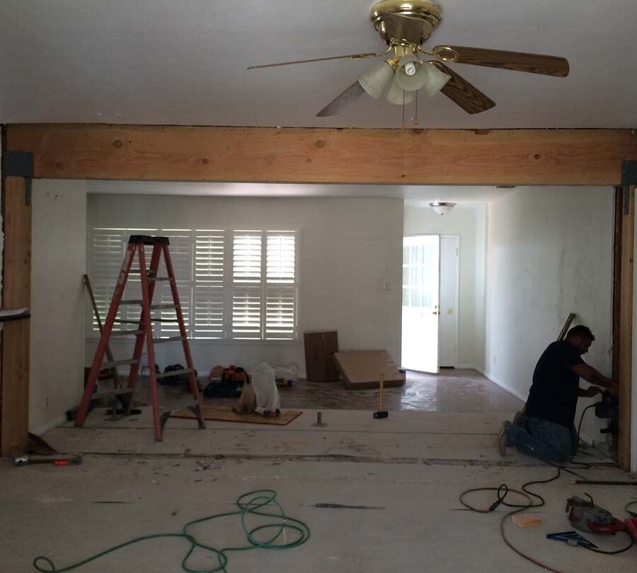Construction of the replacement of a load bearing wall with a beam. Plaster and drywall needs to be applied prior to sanding and painting.