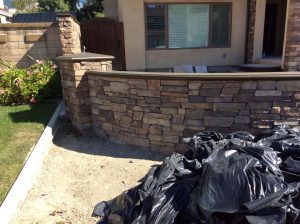 New stone veneer was placed on the face of a new CMU wall to create a bold vintage theme. This wall is topped off with concrete precast lids. Pacificland Constructors