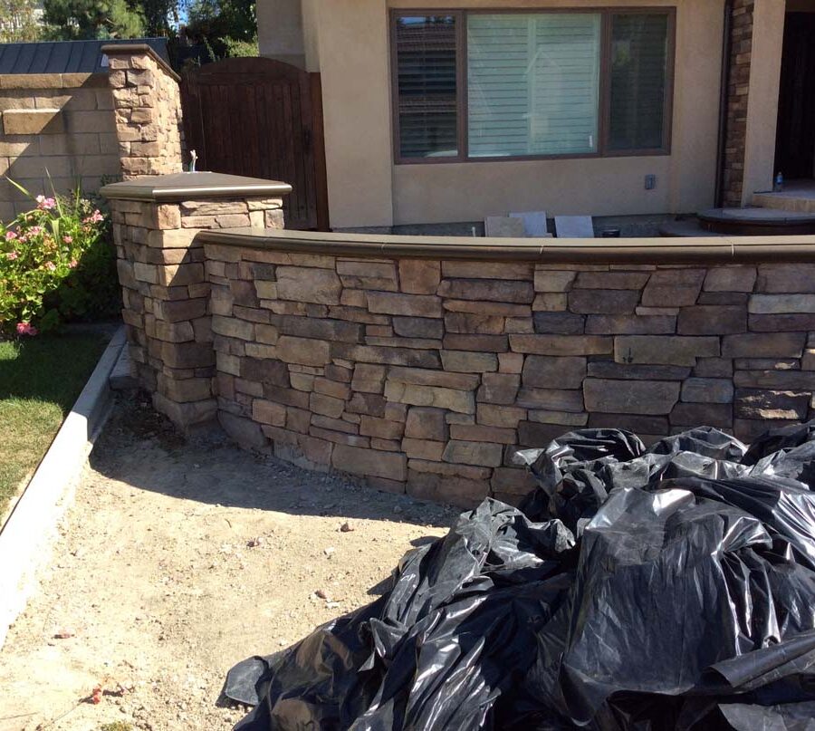 New stone veneer was placed on the face of a new CMU wall to create a bold vintage theme. This wall is topped off with concrete precast lids. Pacificland Constructors