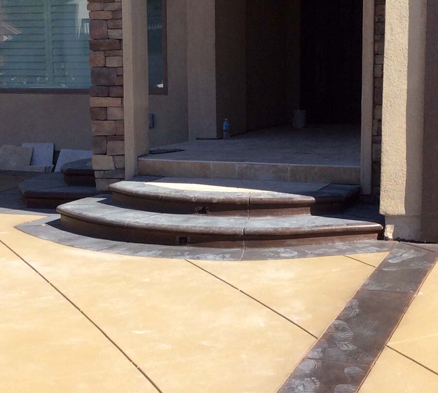 Colored concrete steps at the entrance of a home. Pacificland Constructors