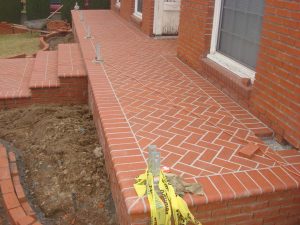 New brick veneer, planter, and raised front patio. New CB44’s are installed within the front patio for a future front porch.