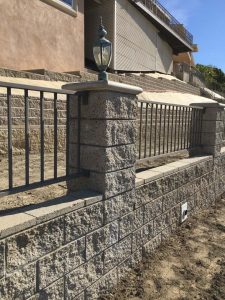 New CMU Split faced fence-wall with Split faced pilasters and concrete precast and cmu wall caps.