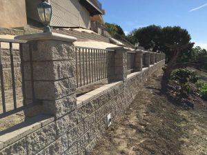 New CMU Split faced fence-wall with Split faced pilasters and concrete precast and cmu wall caps.