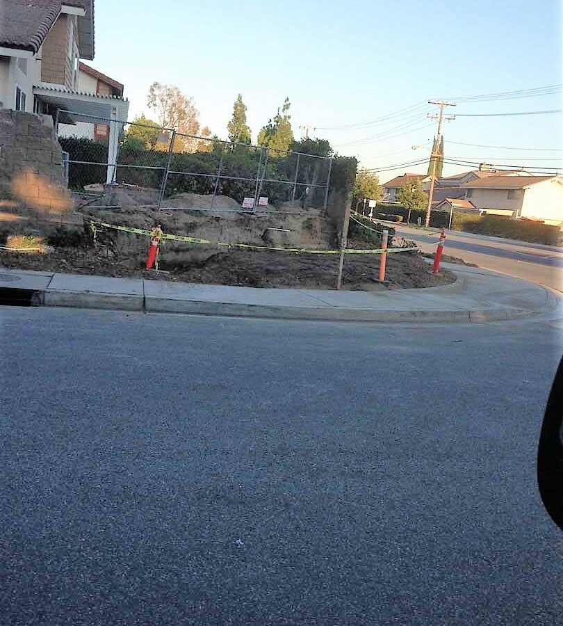 Demolition of the existing freestanding wall that was built without grout. This is an unsafe practice used by unlicensed contractors that steal money from owners by not giving them quality work. Pacificland Constructors