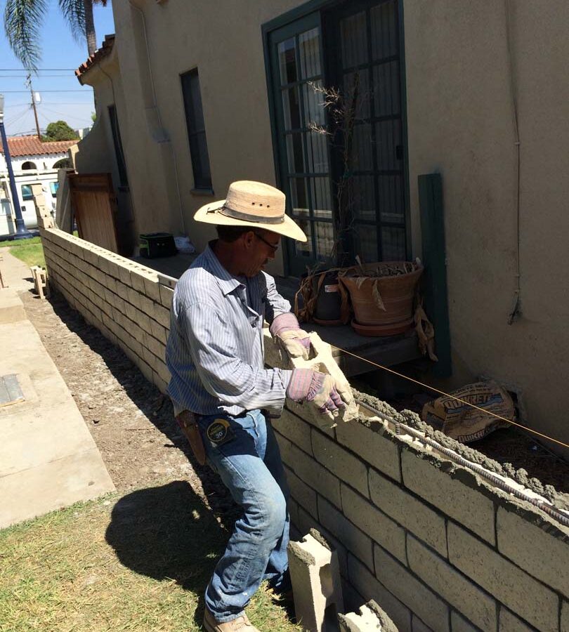 Martin, founder of Pacificland, laying slump block for a home’s side yard. This is a great option to raise the value of your home and create more private living space. Pacificland Constructors