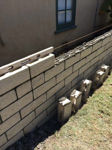 Construction of a new slump block wall for a home’s side yard. This is a great option to raise the value of your home and create more private living space. Pacificland Constructors
