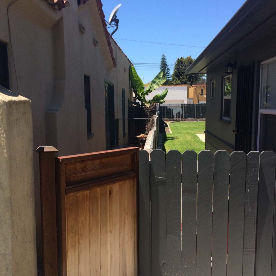 Outdated wooden door and block wall that will be demolished and replaced with a newer strong wall. Pacificland Constructors