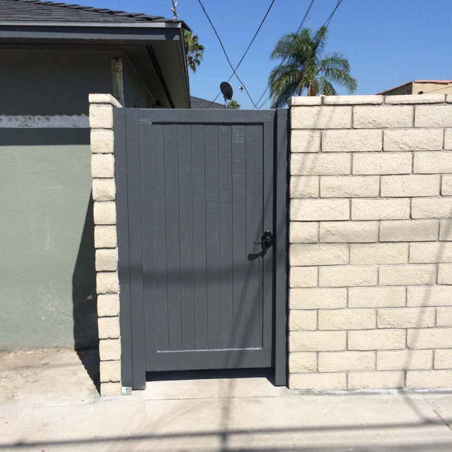 New slump block CMU wall with a wall cap for a home’s backyard. This is a great option to raise the value of your home and create more private living space. It also has access to a back alley with this wooden door. Pacificland Constructors