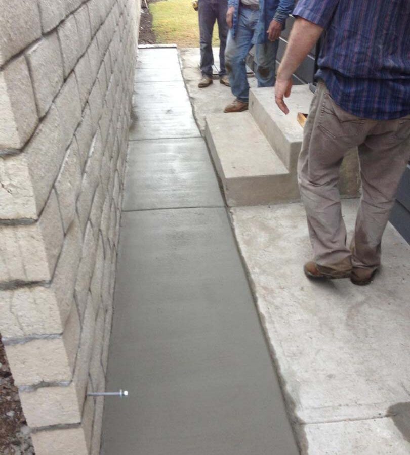 The owner wanted to keep his existing sidewalk and only extend it to the wall for this reason the entire sidewalk was not poured. Pacificland Constructors