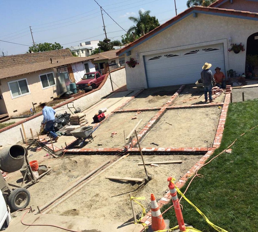 Installing new brick ribbons for a driveway. Pacificland Constructors