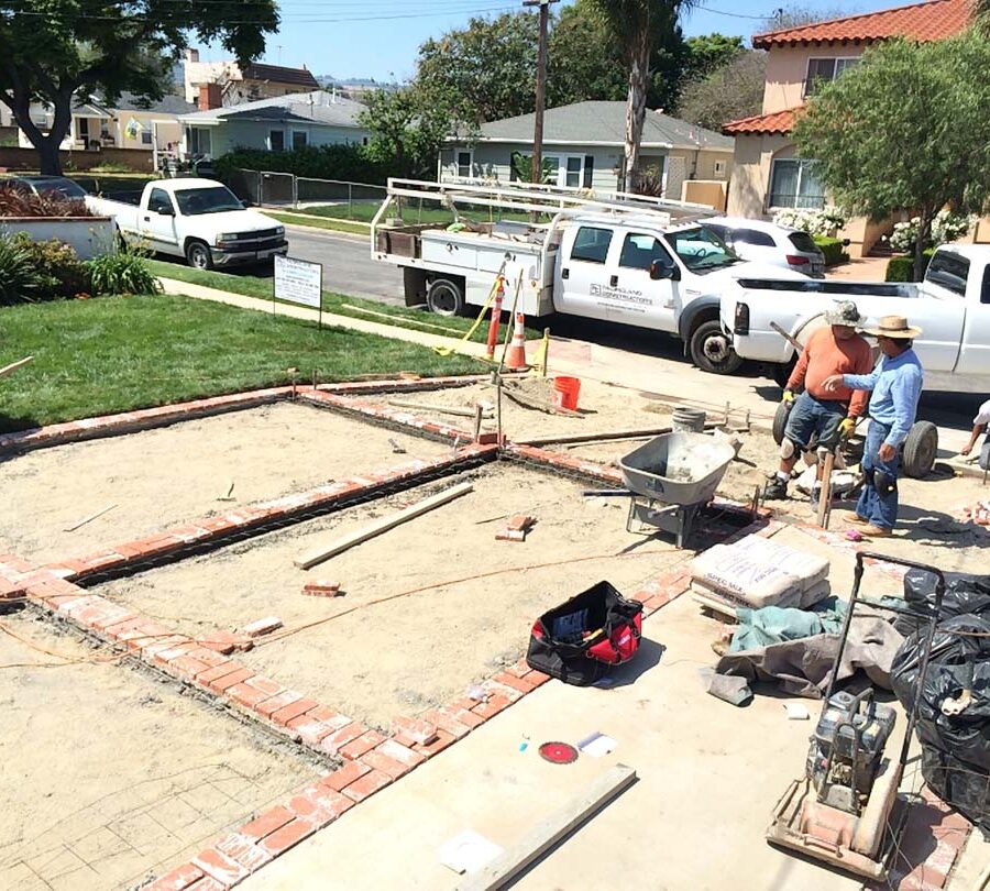 Installing new brick ribbons for a driveway. Pacificland Constructors