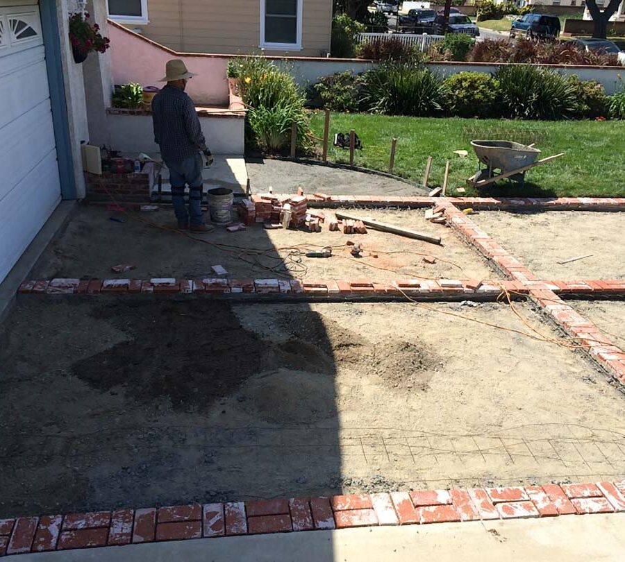 Installing new brick ribbons for a driveway. Pacificland Constructors