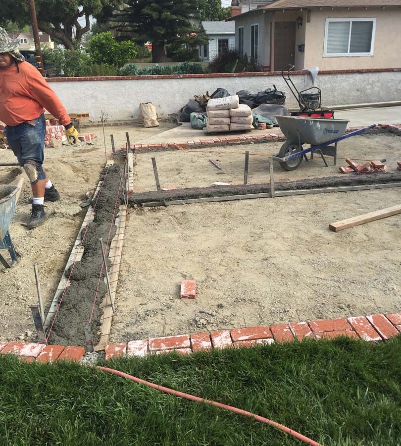 Installing new brick ribbons for a driveway. Pacificland Constructors