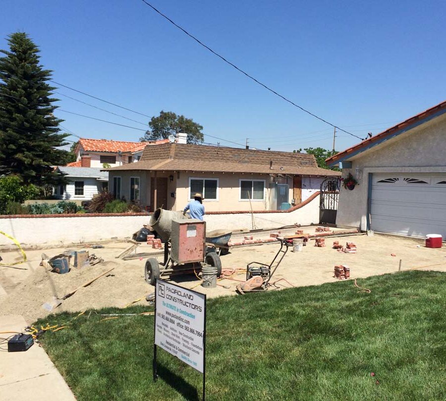 Grading prior to installing new brick ribbons for a driveway. Pacificland Constructors