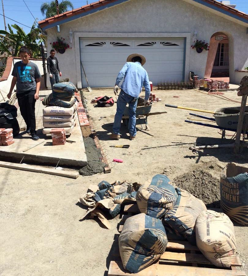 Grading prior to installing new brick ribbons for a driveway. Pacificland Constructors