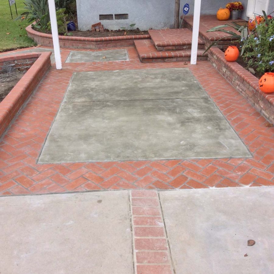 New concrete slab with brick ribbon and new brick finish steps. Pacificland Constructors