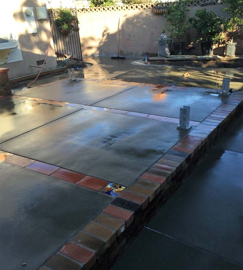 New concrete flatwork with brick ribbon and CBS44’s for a new patio cover.