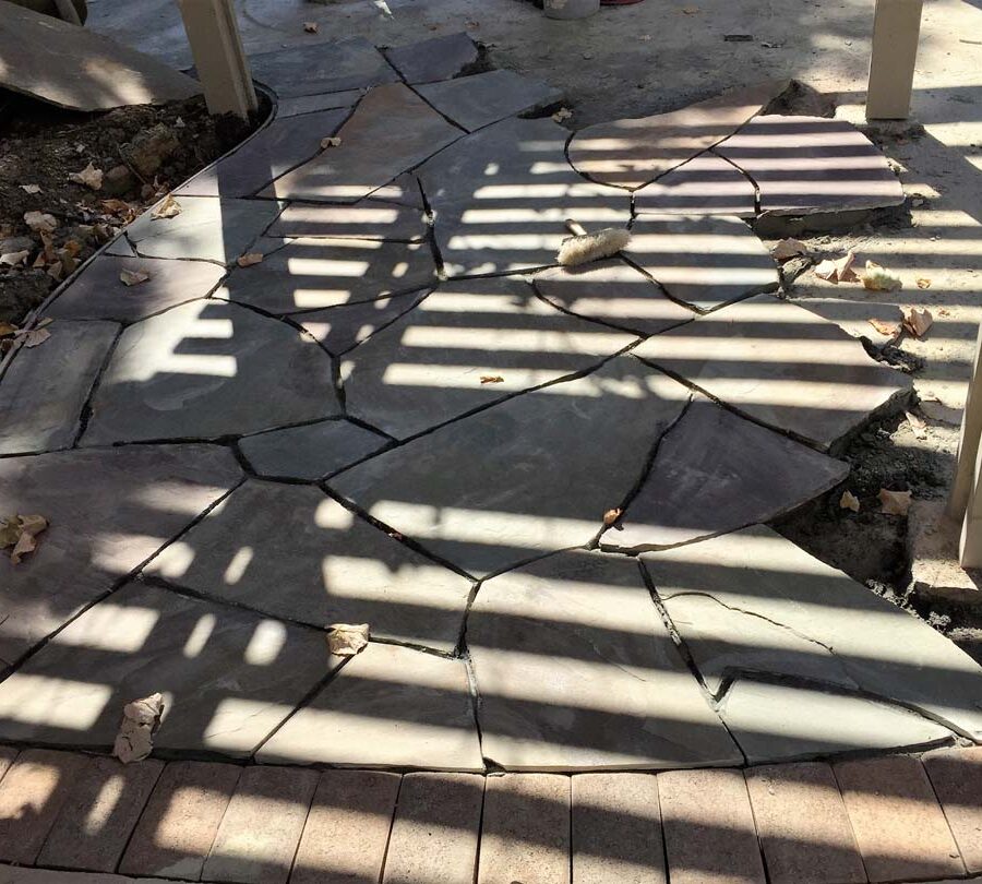 Construction of a flagstone patio gives the home a relaxing theme. Pacificland Constructors