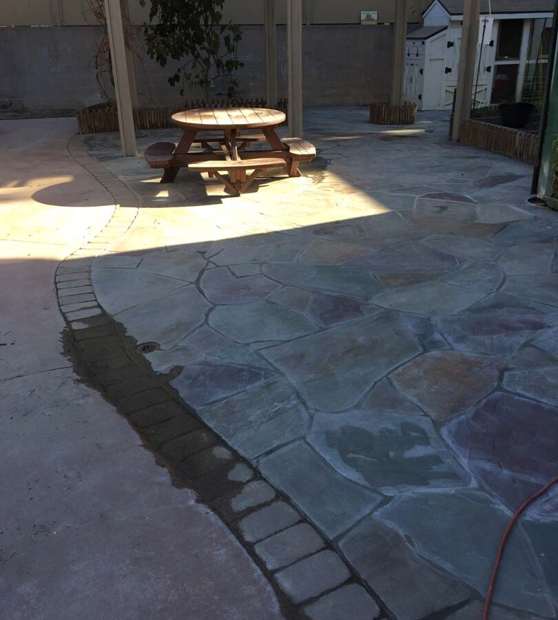 New flagstone patio gives the home a relaxing theme. Pacificland Constructors