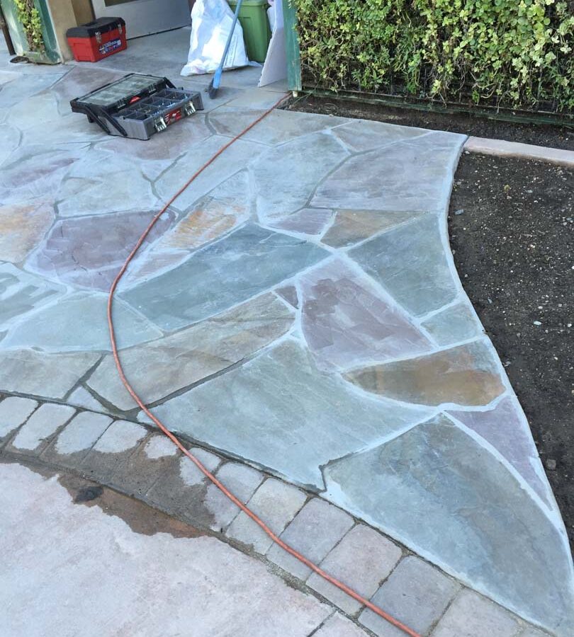 New flagstone patio gives the home a relaxing theme. Pacificland Constructors