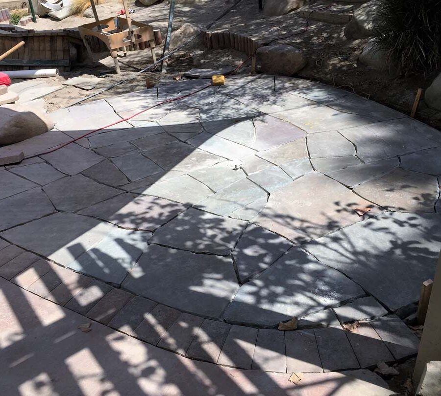 Construction of a flagstone patio gives the home a relaxing theme. Pacificland Constructors