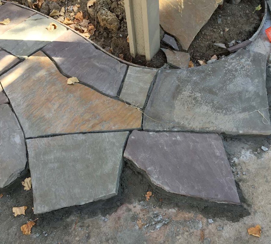 Construction of a flagstone patio gives the home a relaxing theme. Pacificland Constructors